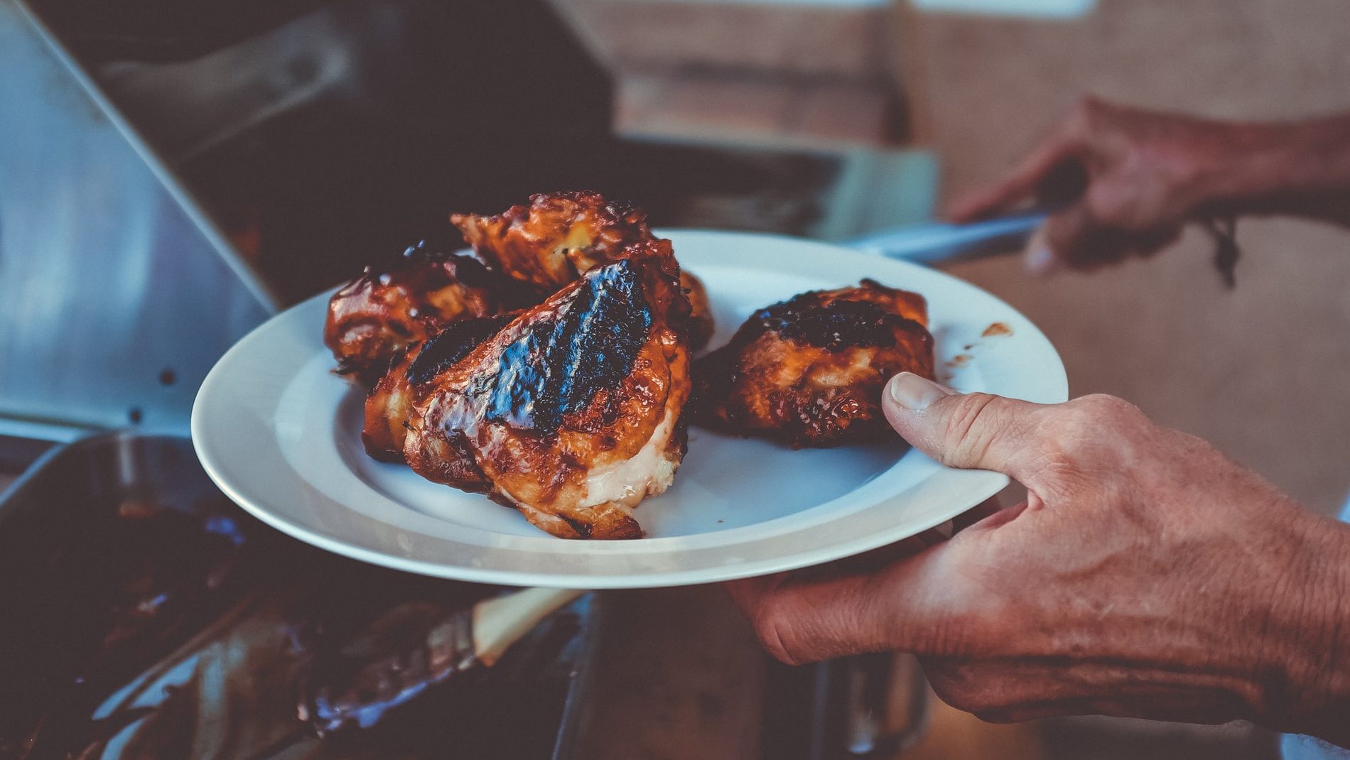 Picture of a person cooking barbecue chicken